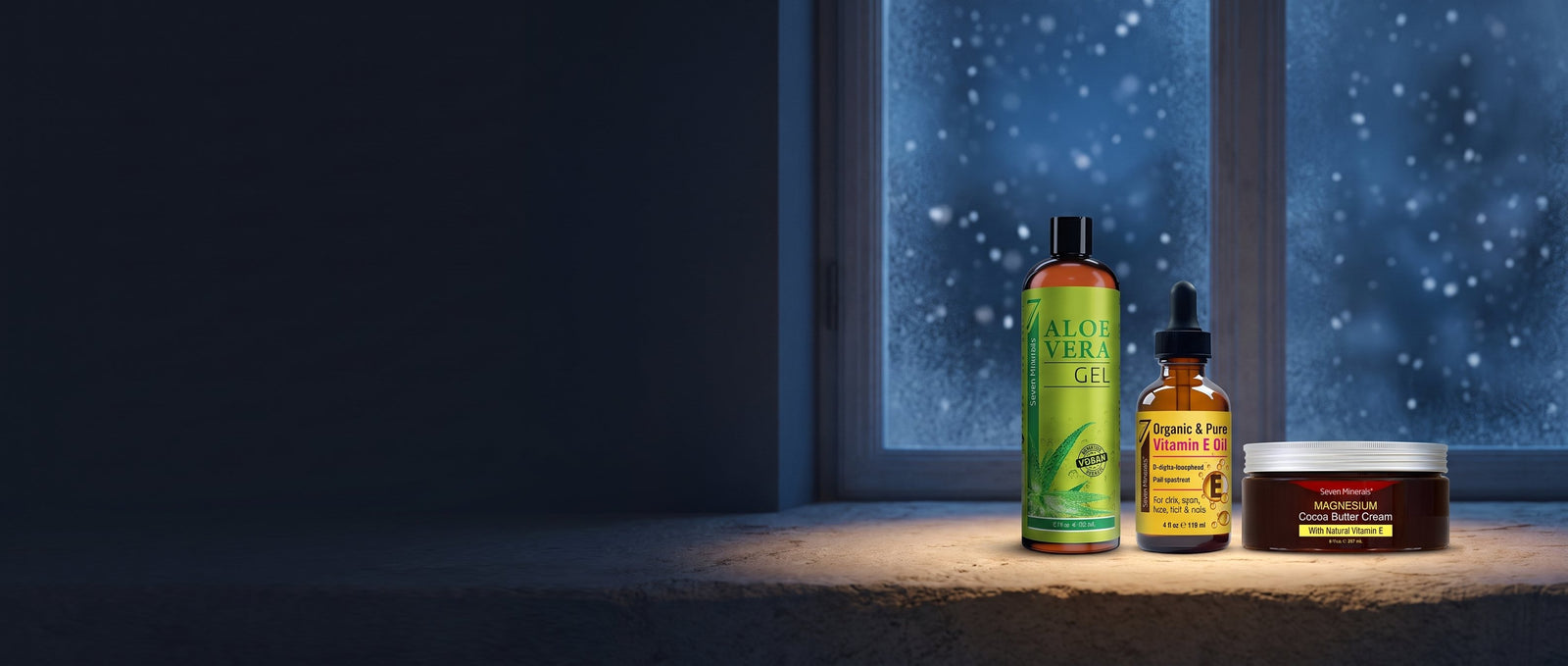 Seven Minerals Aloe Vera Gel, Vitamin E Oil and Magnesium Cocoa Butter Cream on a snowy windowsill